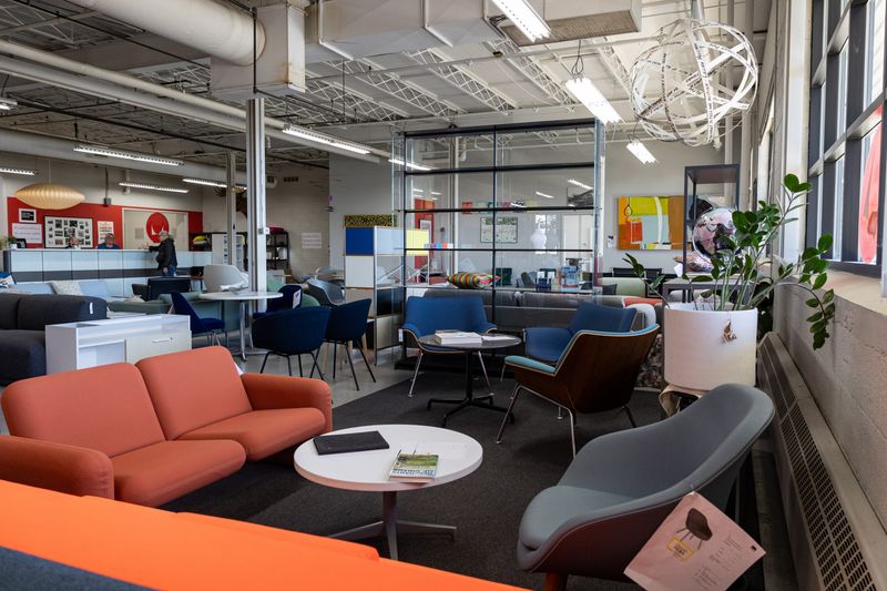 Comfortable chairs and colorful couches are displayed at the Office Outlet on Thursday, April 9.