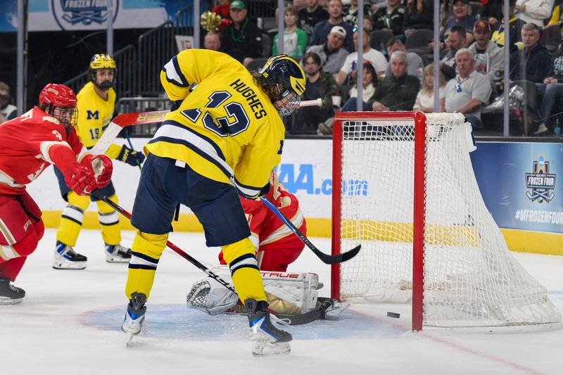 Michigan forward T.J. Hughes scores a goal on Denver goaltender Johnny Hicks during the first period of the NCAA Men’s Ice Hockey semifinals game between the University of Michigan and University of Denver, at T-Mobile Arena, in Las Vegas, April 9, 2026.