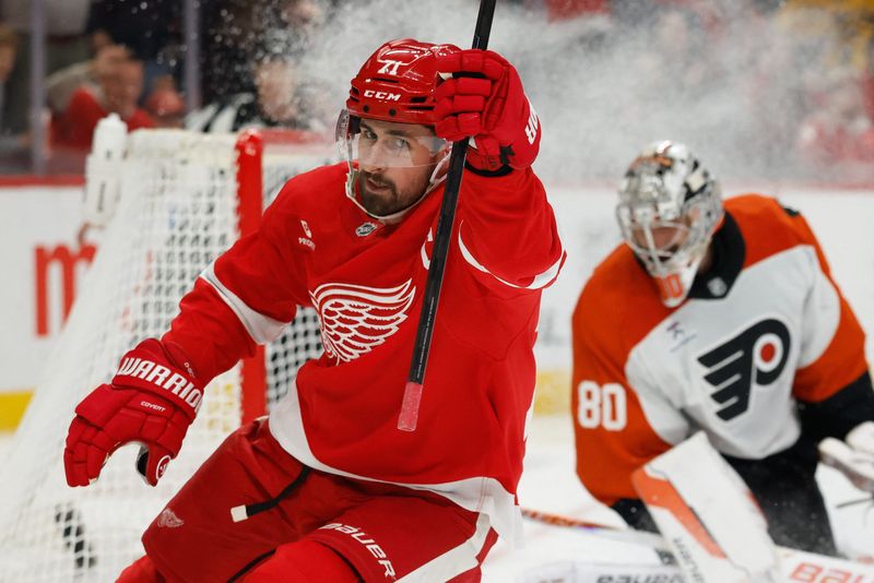 Red Wings center Dylan Larkin (71) celebrates after scoring on Flyers goaltender Dan Vladar (80) in the second period at Little Caesars Arena.