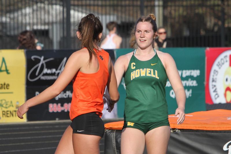 Howell's Norah Hull (right) congratulates Brighton's Kaydence Hoolsema, who won high jump during a dual meet on Thursday, April 9, 2026 at Brighton High School. Both jumpers cleared 5 feet.