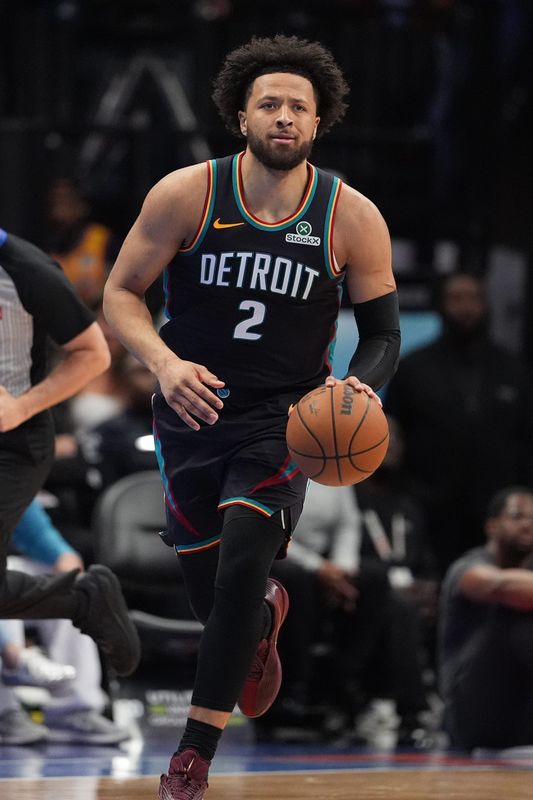 Detroit Pistons guard Cade Cunningham (2) brings the ball up court against the Charlotte Hornets during first quarter at Spectrum Center in Charlotte, North Carolina, on Friday, April 10, 2026.