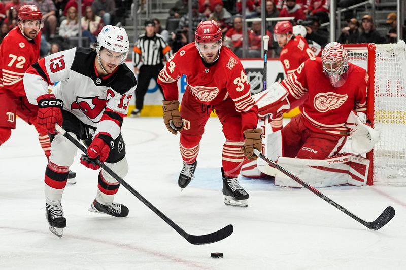 New Jersey Devils center Nico Hischier (13) passes the puck against Detroit Red Wings during the second period at Little Caesars Arena in Detroit on Saturday, April 11, 2026.