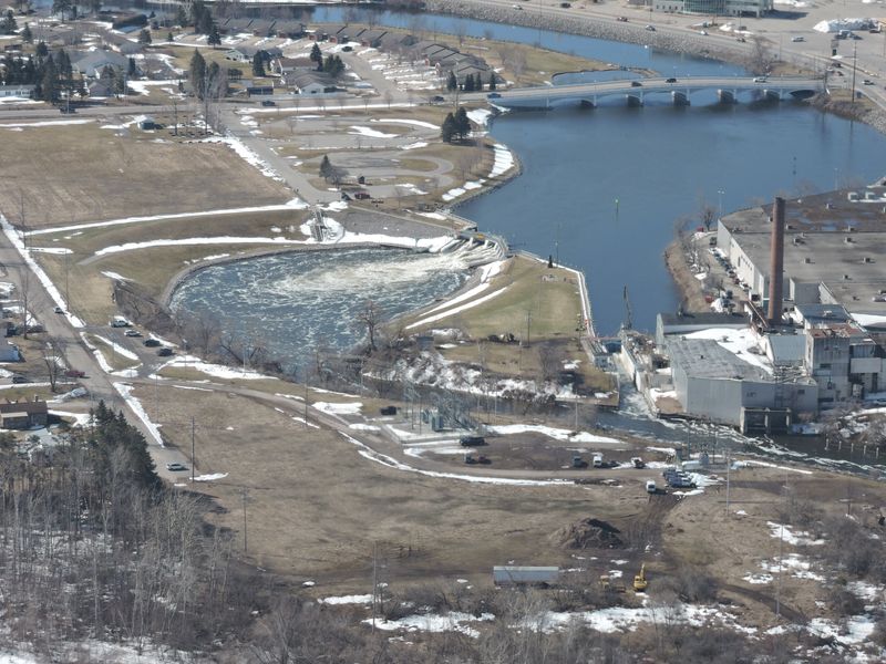 An aerial photo of the Cheboygan Lock and Dam shows water moving through the system and crews taking flood precautionary measures, including pumps and sandbags, on Saturday, April 11, 2026.