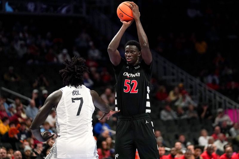 Cincinnati Bearcats center Moustapha Thiam (52) makes a basket from three point range in the first half of the second round of the Phillips 66 Big 12 Menâ€™s Basketball Tournament between the Cincinnati Bearcats and UCF Knights, Wednesday, March 11, 2026, at T-Mobile Center in Kansas City, MO.