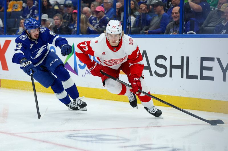 Apr 13, 2026; Tampa, Florida, USA; Detroit Red Wings defenseman Simon Edvinsson (77) controls the puck against the Tampa Bay Lightning in the first period at Benchmark International Arena. Mandatory Credit: Nathan Ray Seebeck-Imagn Images
