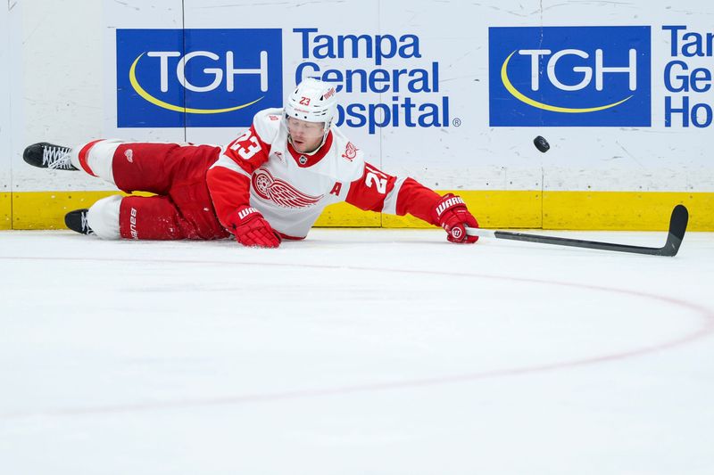 Detroit Red Wings left wing Lucas Raymond (23) looses the puck against the Tampa Bay Lightning in the second period at Benchmark International Arena in Tampa, Florida, on Monday, April 13, 2026.
