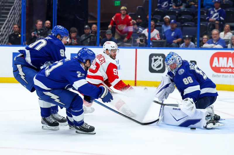 Tampa Bay Lightning goaltender Andrei Vasilevskiy (88) blocks a shot from Detroit Red Wings right wing Alex DeBrincat (93) in overtime at Benchmark International Arena in Tampa, Florida, on Monday, April 13, 2026.