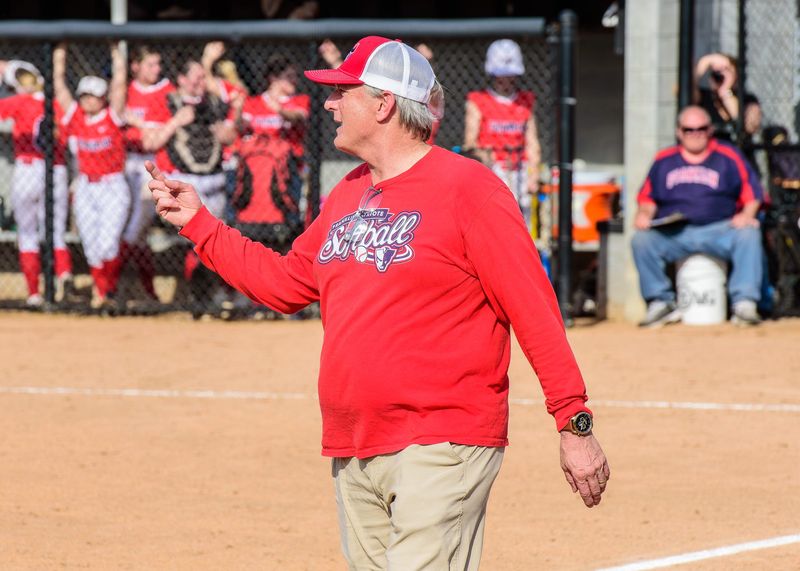 Livonia Franklin coach Paul Newitt talks to his base runners during a Kensington Lakes Activities Association crossover softball game on Monday, April 13, 2026.
