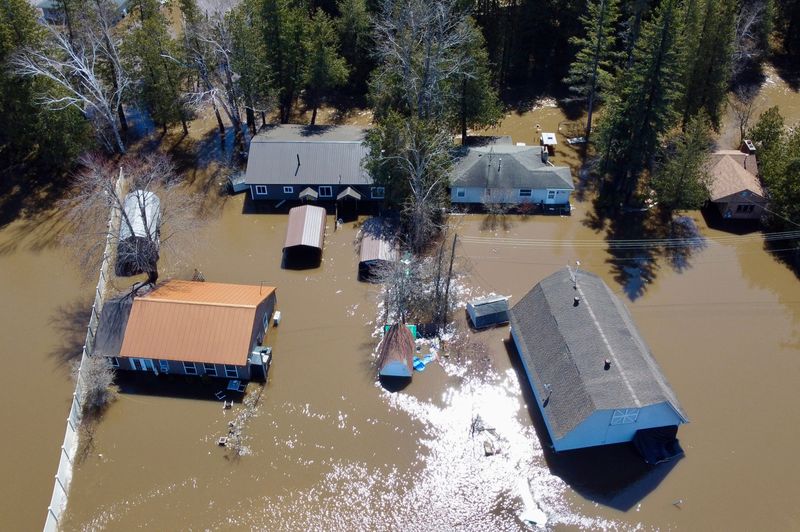 Flood water is seen around a group of houses in Indian River near M68 on Tuesday, April 14, 2026.
