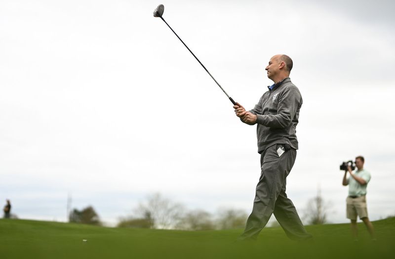 Lansing Mayor Andy Schor hits a golf ball from the first tee, Tuesday, April 14, 2026, at the Groesbeck Golf Course in Lansing. He was the first to hit a ball in a ceremonial drive during a centennial celebration at Groesbeck. "I'm just happy I hit the ball," Schor joked.
