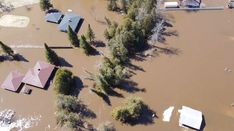 Aerial footage shows houses flooded by the Sturgeon River in Indian River on Tuesday, April 15, 2026.