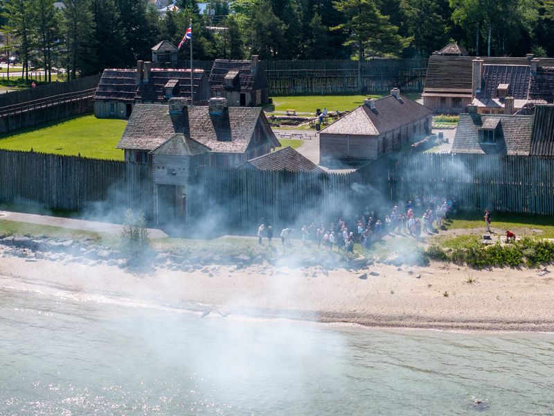 Visitors watch a canon demonstration at Colonial Michilimackinac in Mackinaw City, Tuesday, June 25, 2024.