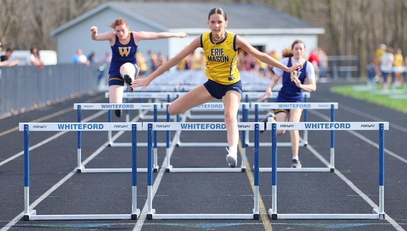Erie Mason's Lexi Carner opens up a lead over Carolyn Mohler and Kaia Rasor of Whiteford in the high hurdles during wins over Whiteford and Britton Deerfield on Tuesday, April 15, 2026.