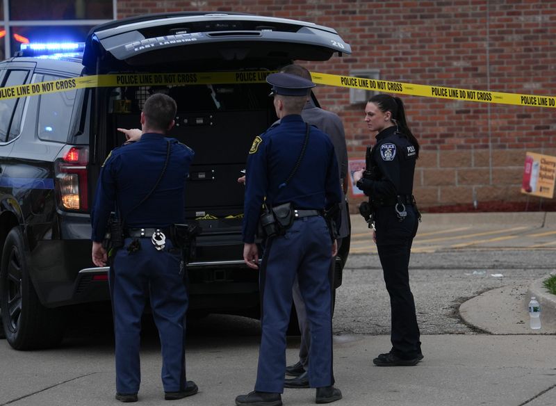 First responders work near the intersection of West Lake Lansing and Abbot Roads in East Lansing, Wednesday, April 15, 2026. Officials say police responded to a report of a stabbing at a business around 6 p.m., encountered a suspect and fatally shot the man.