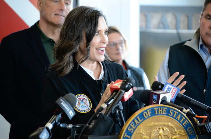Gov. Gretchen Whitmer speaks on April 16, 2026 in Cheboygan after getting an up-close look at the Cheboygan Lock and Dam Complex. Whitmer was joined by State Sen. John Damoose, law enforcement, DNR representatives and others involved in efforts to prevent the dam from failing.