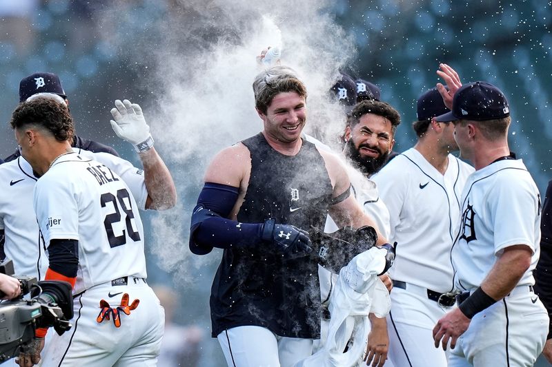 Detroit Tigers second baseman Colt Keith (33), center, is congratulated by teammates after batting a walk-off single against Kansas City Royals to win the game 10-9 at Comerica Park in Detroit on Thursday, April 16, 2026.