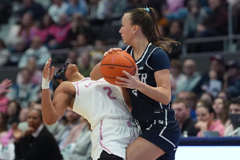 Feb 7, 2026; Hartford, Connecticut, USA; Butler Bulldogs guard Anna Wypych (2) called for the foul against UConn Huskies guard Kk Arnold (2) in the first half at PeoplesBank Arena. Mandatory Credit: David Butler II-Imagn Images