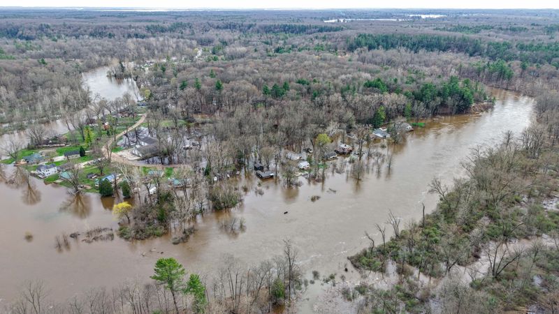 Houses flooded downstream from the Croton Dam along the Muskegon River during an emergency evacuation due to flood waters on April 16, 2026, in Newaygo, Mich.