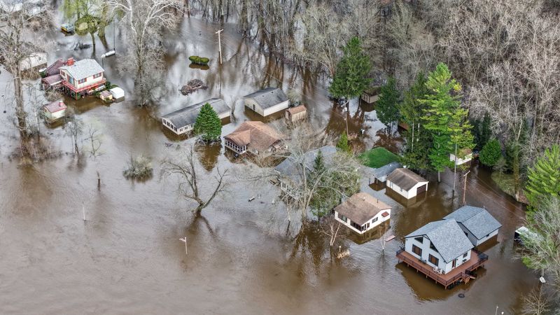 Houses flooded downstream from the Croton Dam along the Muskegon River during an emergency evacuation due to flood waters on April 16, 2026, in Newaygo, Mich.