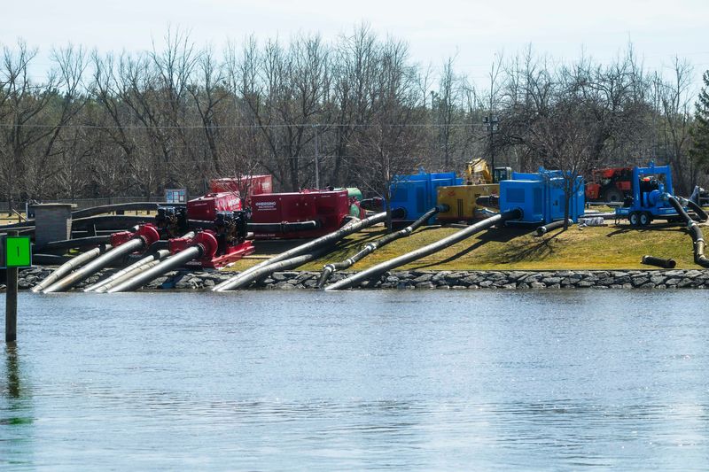 Large-volume water pumps are used to divert water from entering the Cheboygan Lock and Dam Complex in Cheboygan on Friday, April 17, 2026. As of Friday morning, the water level at Cheboygan Dam had decreased slightly from the day before.