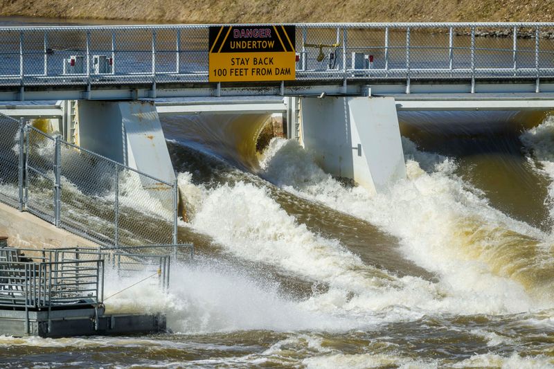 Water flows through the Cheboygan Dam as large-volume water pumps are used to divert water around the dam and back into the Cheboygan River on Friday, April 17, 2026. As of Friday morning, the water level at Cheboygan Dam had decreased slightly from the day before.