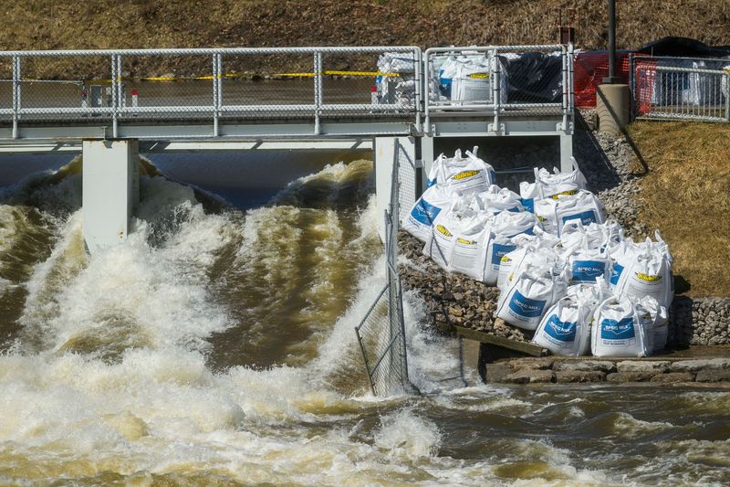 Water flows through the Cheboygan Dam as large-volume water pumps are used to divert water around the dam and back into the Cheboygan River on Friday, April 17, 2026. As of Friday morning, the water level at Cheboygan Dam had decreased slightly from the day before.
