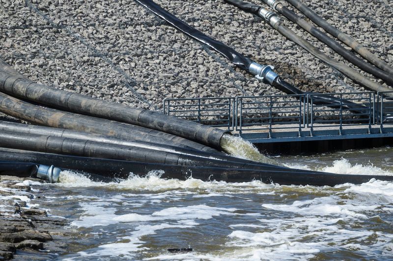 Water flows through the Cheboygan Dam as large-volume water pumps are used to divert water around the dam and back into the Cheboygan River on Friday, April 17, 2026. As of Friday morning, the water level at Cheboygan Dam had decreased slightly from the day before.