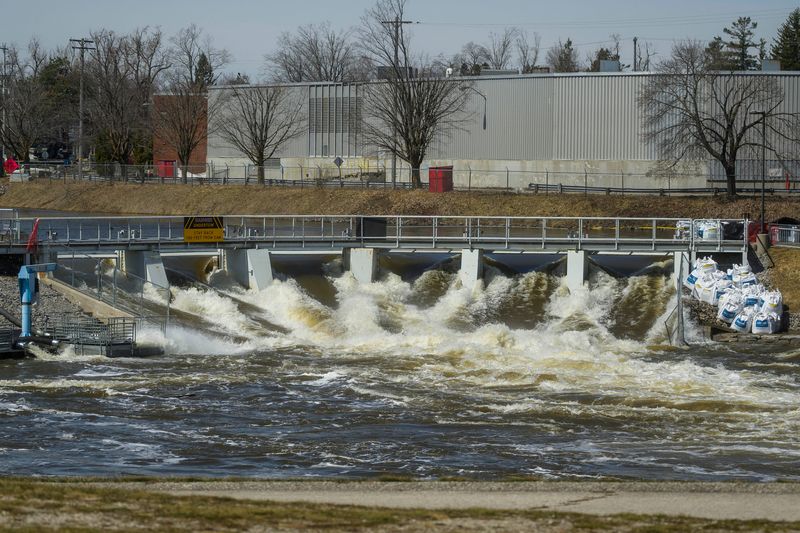 Water flows through the Cheboygan Dam as large-volume water pumps are used to divert water around the dam and back into the Cheboygan River on Friday, April 17, 2026. As of Friday morning, the water level at Cheboygan Dam had decreased slightly from the day before.