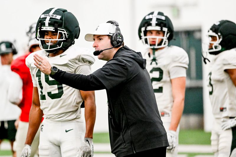 Michigan State's offensive coordinator Nick Sheridan, right, talks with Charles Taplin during spring football practice on Tuesday, April 14, 2026, in East Lansing.