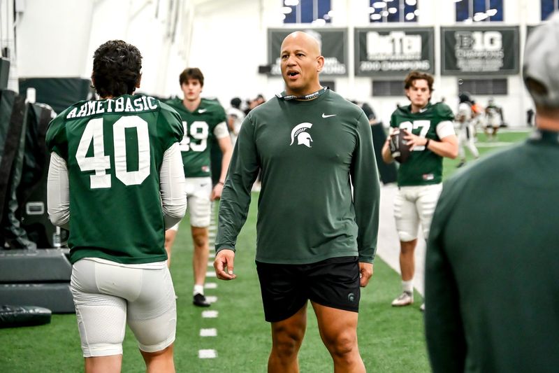 Michigan State's assistant head coach/special teams coordinator LeVar Woods talks with Tarik Ahmetbasic, left, and other on special teams during spring football practice on Tuesday, April 14, 2026, in East Lansing.