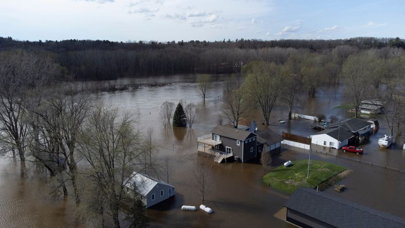 Flooded houses in Cedar Creek Township sit in the flooding waters of the Muskegon River on Friday, April 17, 2026.