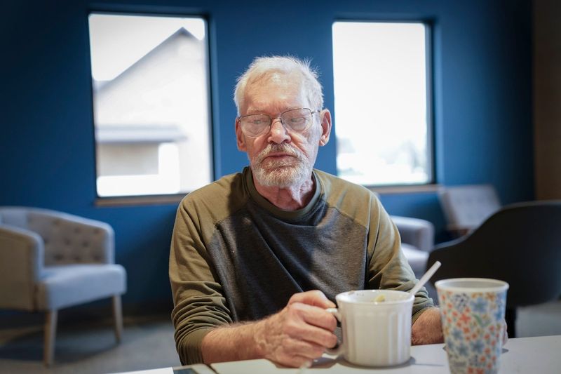 Douglas Foster, 83, eats some noodle soup at the Inspire Church in Fremont where he is staying on Friday, April 17, 2026, after he evacuated his flooding house on the Muskegon River last week.