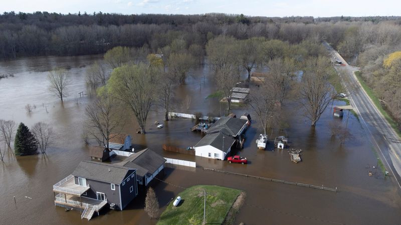 Flooded houses in Cedar Creek Township sit in the flooding waters of the Muskegon River on Friday, April 17, 2026.