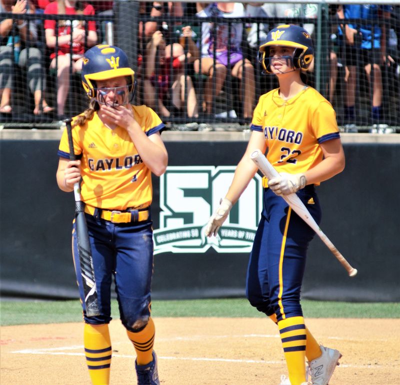 When Nora Bethuy (left) was just a freshman, she chipped her tooth on a play at the plate during GHS's state finals victory over Vicksburg on Saturday, June 17, 2023.