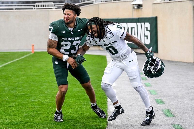 Michigan State's Kenny Soares Jr., left, laughs with Cam Edwards after Soares won the hotdog eating competition during the football Spring Showcase on Saturday, April 18, 2026, at Spartan Stadium in East Lansing.