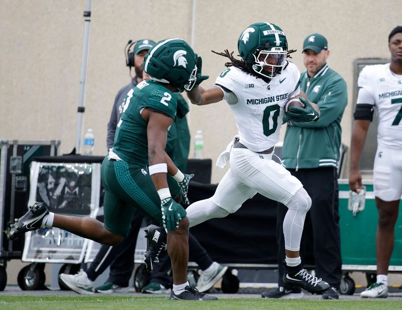 Michigan State running back Cam Edwards, right, runs against safety Devin Vaught (2) during the MSU Football Spring Showcase, Saturday, April 18, 2026, in East Lansing. (Al Goldis/Special to The Detroit News)