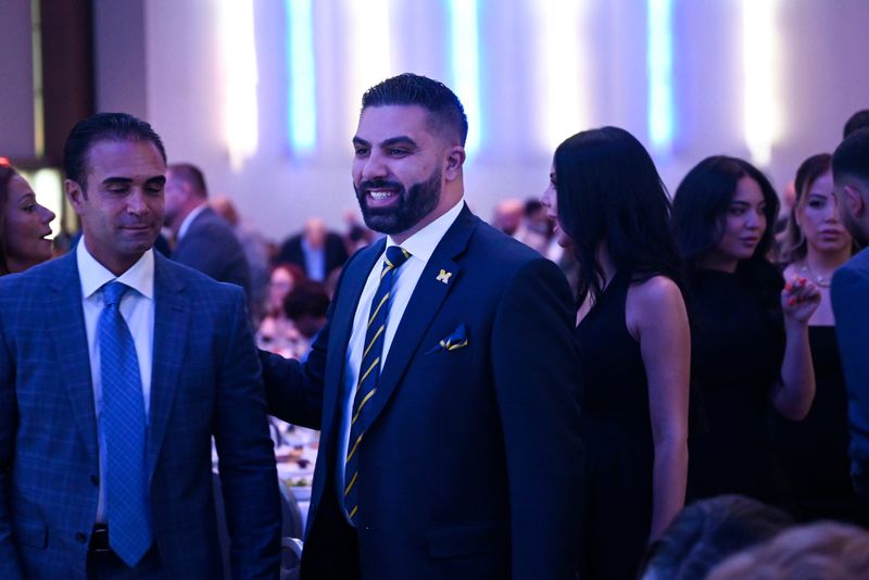 University of Michigan Board of Regents candidate Amir Makled heads to his table during the Michigan Democratic Party Legacy Dinner, Saturday, April 18, 2026, at Huntington Place in Detroit. (Jose Juarez/Special to Detroit News)