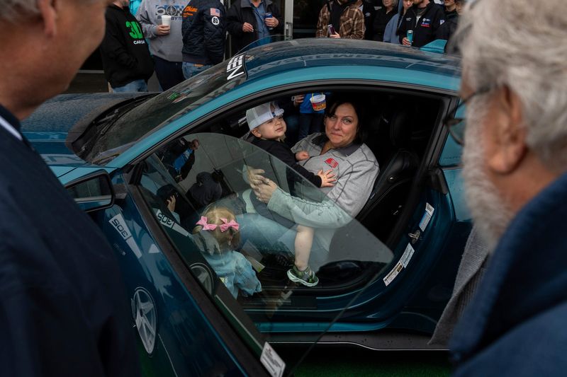 Dana Keethler, 50, sits inside her customized Saleen Mustang during a National Mustang Day celebration at the Flat Rock Assembly Plant in Flat Rock on Saturday, April 18, 2026.