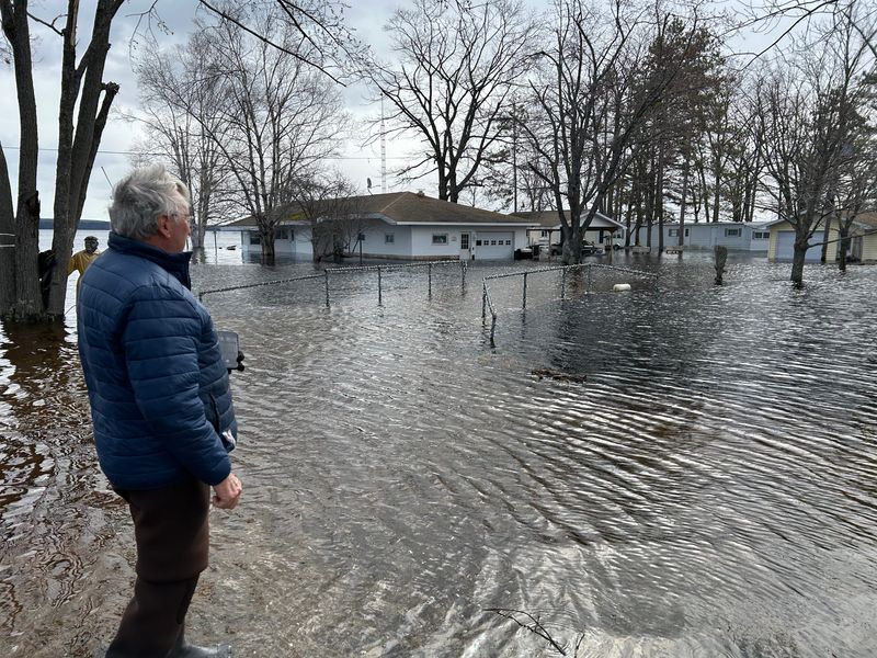 Grant Township Supervisor Gil Archambo surveys flooded cottages his family owns along Black Lake in Cheboygan County on Sunday, April 20, 2026.