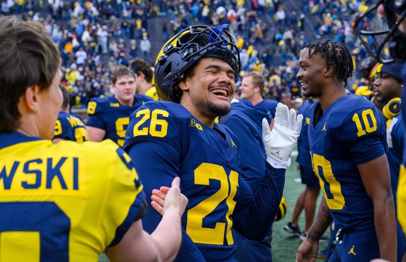 Michigan junior safety Taylor Tatum (26) smiles with his teammates after playing in the Maize vs. Blue Spring Football Game at Michigan Stadium in Ann Arbor on Saturday, April 18, 2026.