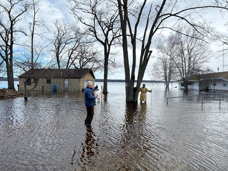 Grant Township Supervisor Gil Archambo surveys damage to a row of cottages he owns on Black Lake in Cheboygan County on Sunday, April 20, 2026.