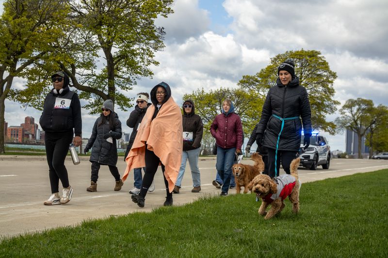 Community members participate in a crime victim support walk around Belle Isle on Sunday, April 19, 2026.