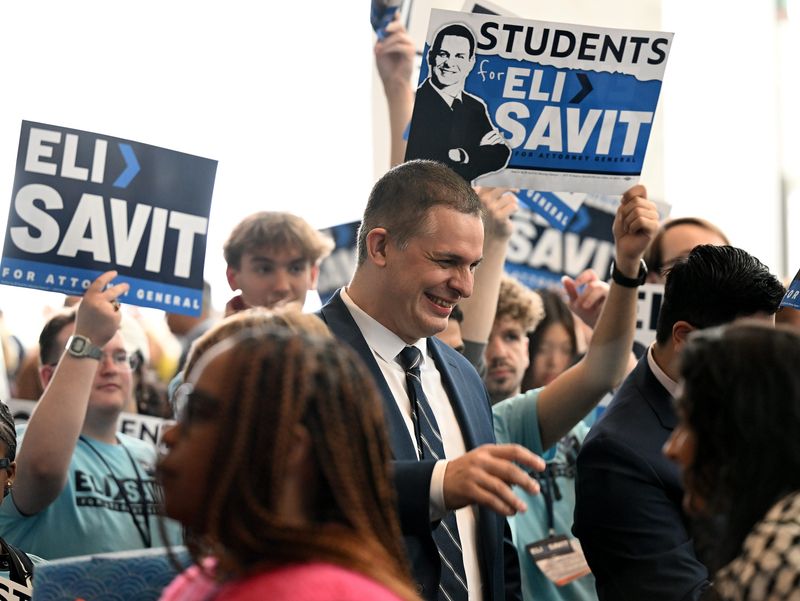Attorney General candidate Eli Savit, the current Washtenaw County prosecutor, greets people during the Michigan Democratic Party nominating convention at Huntington Place on April 19, 2026 in Detroit.