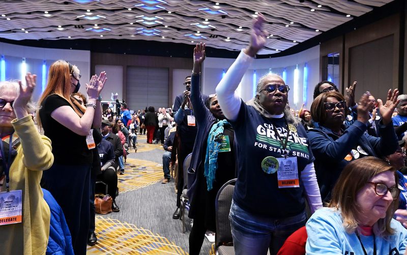 Debbie Rogers, at right, in Greene shirt, and Onie Taylor, to right, both of Bay City cheer along with many other people as Abdul El-Sayed, candidate for U.S. Senate, speaks during the Michigan Democratic Party nominating convention at Huntington Place on April 19, 2026 in Detroit.