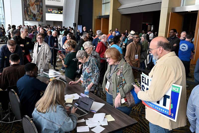 People get their access code so that they can vote during the Michigan Democratic Party nominating convention at Huntington Place on April 19, 2026 in Detroit. Not everyone had to vote this way but some people did not receive the link or email with their access code, so this line is for them to still be able to vote.
