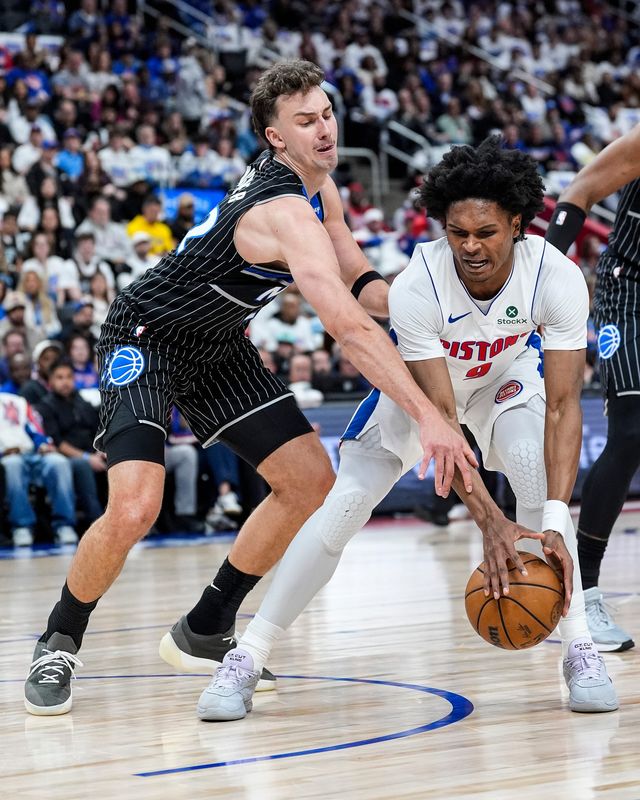 Detroit Pistons guard Ausar Thompson (9) and Orlando Magic forward Franz Wagner (22) battle for the ball during the first half of Game 1 of the first round of the NBA playoffs at Little Caesars Arena in Detroit on Sunday, April 19, 2026.