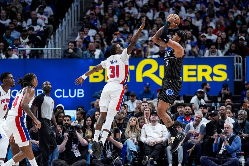 Detroit Pistons guard Javonte Green (31) defends Orlando Magic forward Paolo Banchero (5) during the first half of Game 1 of the first round of the NBA playoffs at Little Caesars Arena in Detroit on Sunday, April 19, 2026.