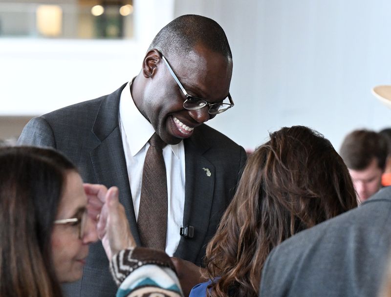 Lt. Gov. Garlin Gilchrist, running for Secretary of State, smiles while talking with his family and others during the Michigan Democratic Party nominating convention at Huntington Place on April 19, 2026 in Detroit.