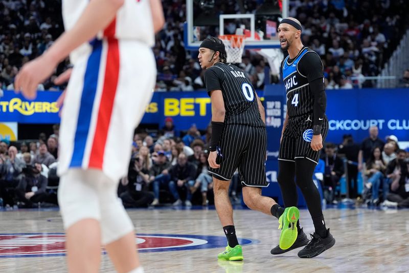 Orlando Magic guard Anthony Black (0) and guard Jalen Suggs (4) celebrate a play against Detroit Pistons during the second half of Game 1 of the first round of the NBA playoffs at Little Caesars Arena in Detroit on Sunday, April 19, 2026.