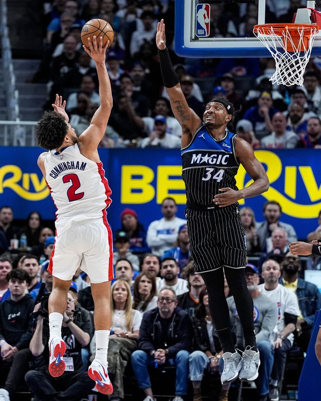 Detroit Pistons guard Cade Cunningham makes a floater against Orlando Magic center Wendell Carter Jr. during the second half of Game 1 of the first round of the NBA playoffs at Little Caesars Arena in Detroit on Sunday, April 19, 2026.